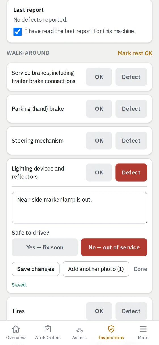 The walk-around checklist with a lighting defect written up, a photo attached, and No — out of service chosen.